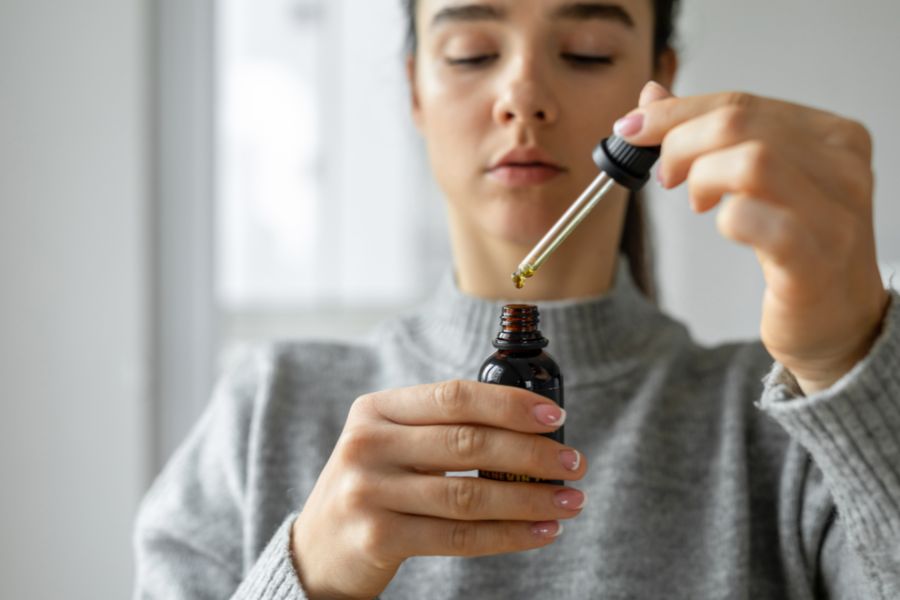 a lady holding a tincture